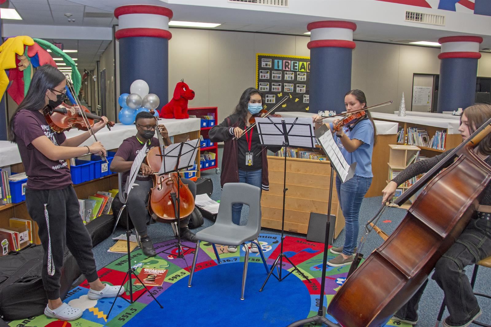 Cypress Lakes High School orchestra members perform during the Tipps Elementary School Winter Wonderland Literacy Night.